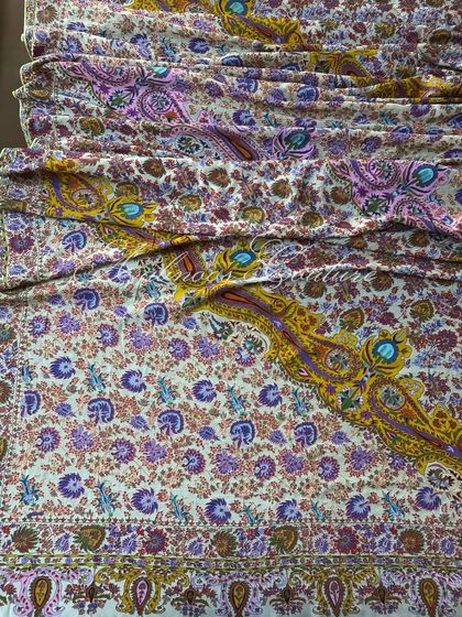 The dupatta is laid out to display its generous length and the grandeur of its all-over pattern, making it a true heirloom piece.