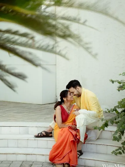 A quiet, romantic moment shared between the couple on the steps during their Haldi celebrations. It's a beautiful contrast to the usual high energy of the event.