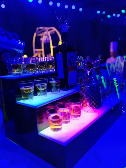 Shots are prepped and ready to go on an illuminated, multi-tiered display. This ensures quick service and adds to the visual appeal of the bar.