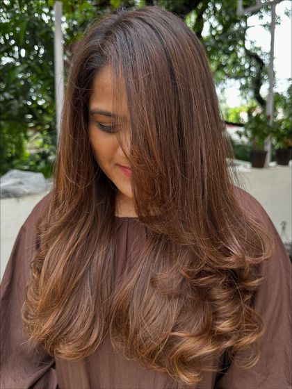 A beautiful color refresh for this client, getting her vacay-ready. I added soft, natural-looking highlights to her long hair and finished with a layered cut and bouncy curls for a glamorous feel.