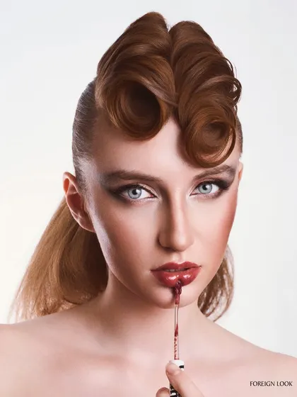 A provocative beauty shot for a lip product. The dripping lip gloss creates a dynamic and edgy visual, while the lighting remains clean and focused on the face.