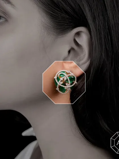 Our stunning statement tops feature exquisite Zambian emeralds intertwined with sparkling round diamonds and 18k gold in a captivating design.