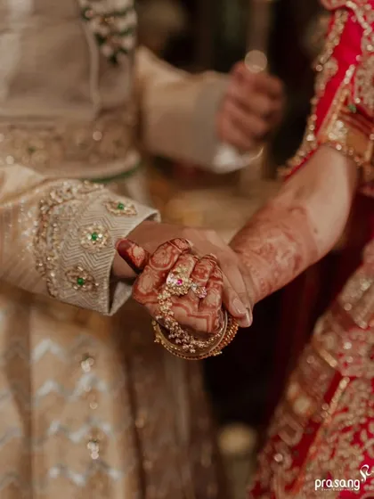 A close-up on the union of hands, a symbol of their lifelong bond. The intricate details of the bride's henna and the groom's attire are a testament to the rich tapestry of traditions I weave into each wedding.