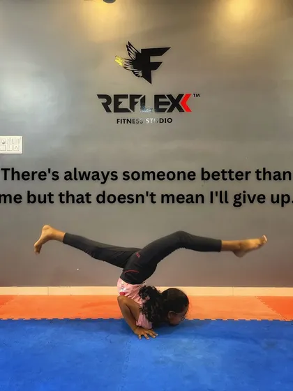 There's always someone better, but that doesn't mean I'll give up. This student shows incredible focus and strength in this arm balance pose.