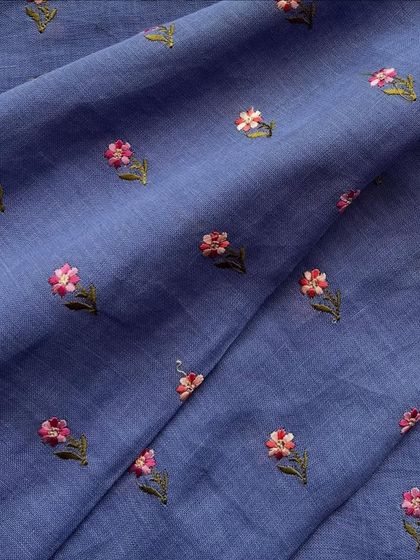 The same charming embroidered linen, shown here in a beautiful periwinkle blue. The delicate floral butis make it a lovely choice for a comfortable yet stylish kurta.