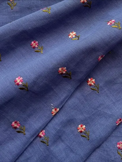 The same charming embroidered linen, shown here in a beautiful periwinkle blue. The delicate floral butis make it a lovely choice for a comfortable yet stylish kurta.