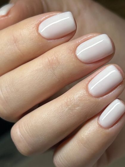 A clean and simple milky white manicure. This semi-sheer white offers a soft, elegant look that enhances the natural beauty of the nails.