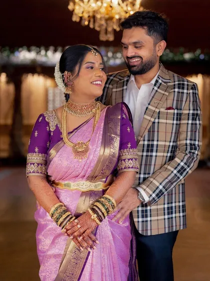 A beautiful portrait of the happy couple at their engagement. The bride's soft lavender saree and traditional jewelry are paired with a luminous makeup look that is both elegant and timeless.