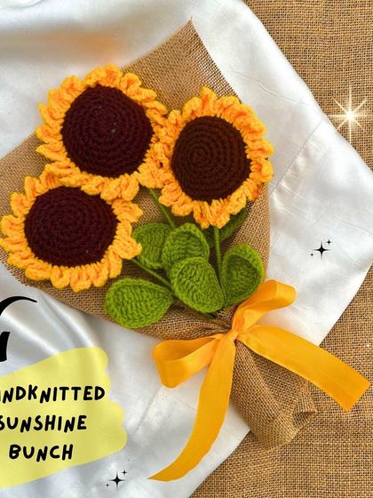 Our hand-knitted 'Sunshine Bunch' features three crochet sunflowers wrapped in burlap, a perfect rustic and cheerful gift.