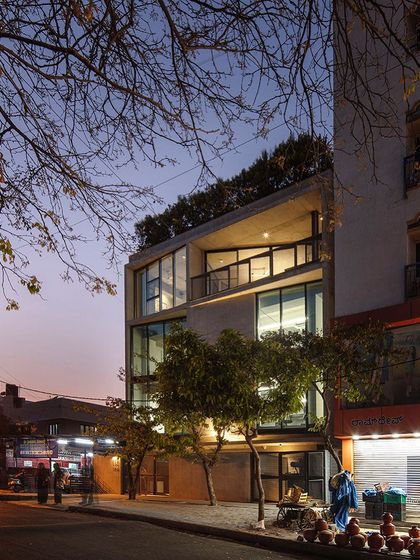 Our studio at dusk, seen from the street. The warm interior light reveals the activity within, turning the building into a beacon of creativity in the neighborhood. The design includes two floors for our studio and two for future multidisciplinary use.
