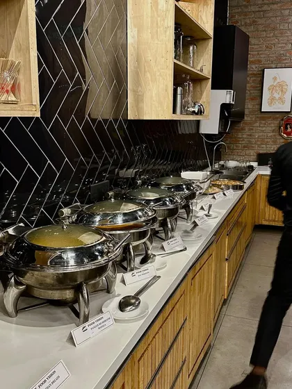 A full view of the buffet line, with a variety of dishes served in elegant chafing dishes.