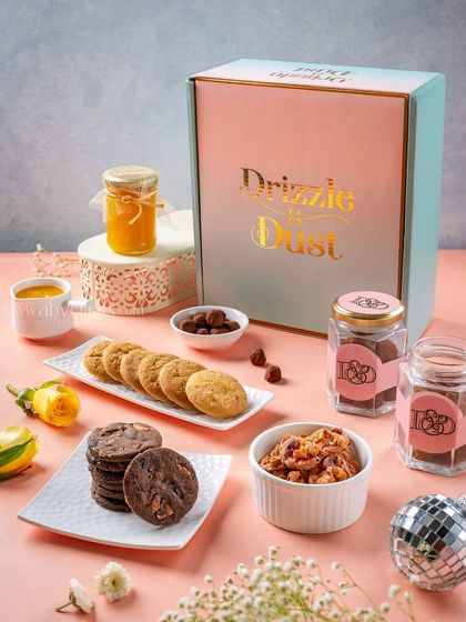 A Drizzle & Dust gift box with cookies and jam, creating an elegant and appealing hamper shot.