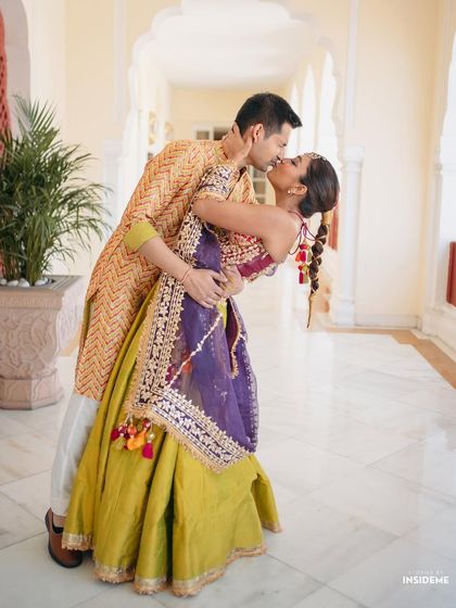 A full-length shot capturing a beautiful dance move. Mishi's entire look, from her colorful outfit to her unique hairstyle, is designed for movement and celebration.