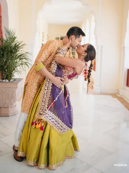 A full-length shot capturing a beautiful dance move. Mishi's entire look, from her colorful outfit to her unique hairstyle, is designed for movement and celebration.