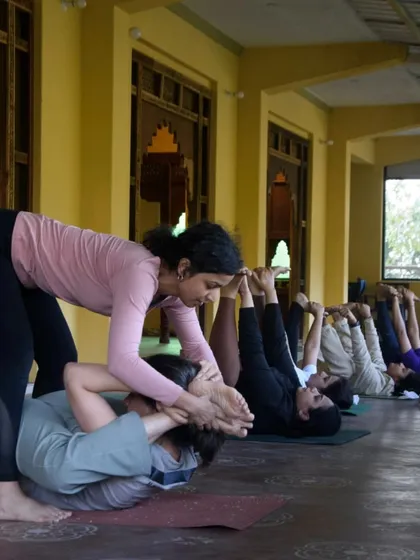 A core part of my retreats is providing hands-on, personal guidance. Here, I'm helping a student find a deeper expression in her pose during our Dehradun retreat, ensuring she feels supported and safe in her practice.