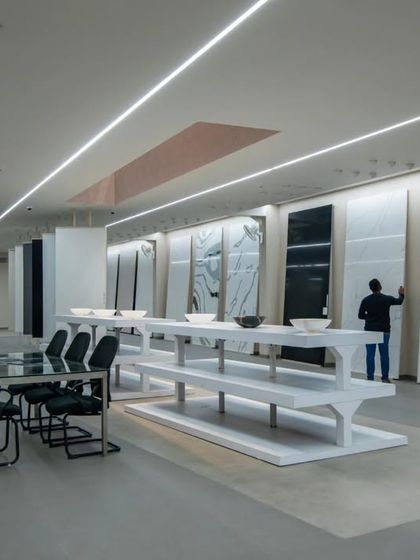 More images from the Krsimar marble showroom, detailing the sliding panel display system and the clean, spacious layout designed for an optimal client experience.