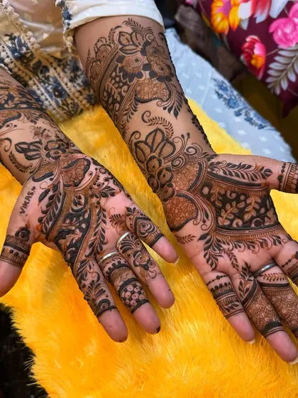 An elegant design that leaves some skin showing, typical of Arabic and Indo-Western styles. The focus is on flowing vines and floral patterns.