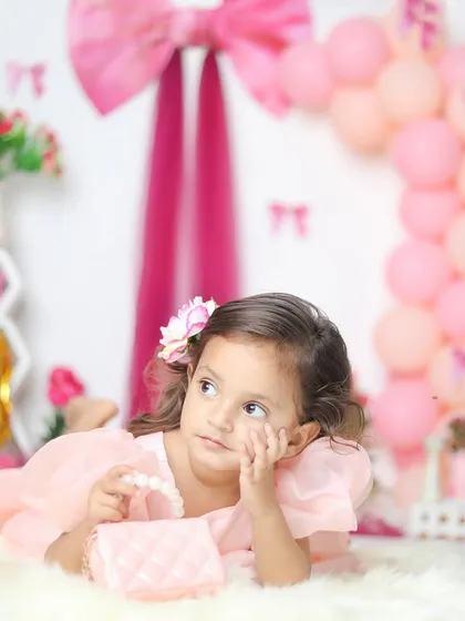 A dreamy, thoughtful pose from our little princess. The soft fur rug and her little purse add sweet details to the shot.