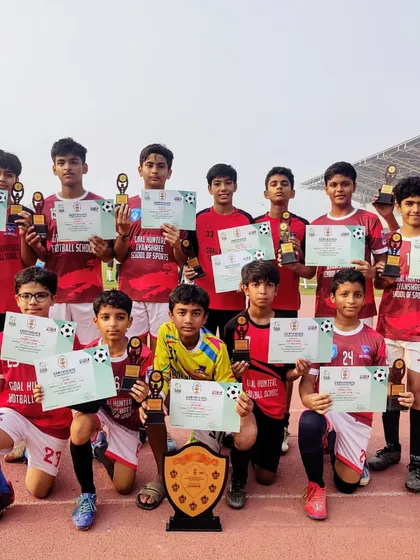 The U-13 team proudly displaying their trophies and certificates after winning the RSA Shield Cup.