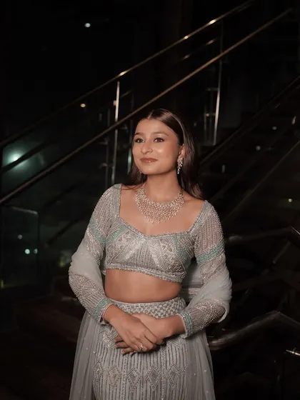 Sangeet glam that is both modern and elegant. The look features a flawless base, soft smokey eyes, and a neutral lip, allowing her natural beauty and stunning outfit to take center stage.