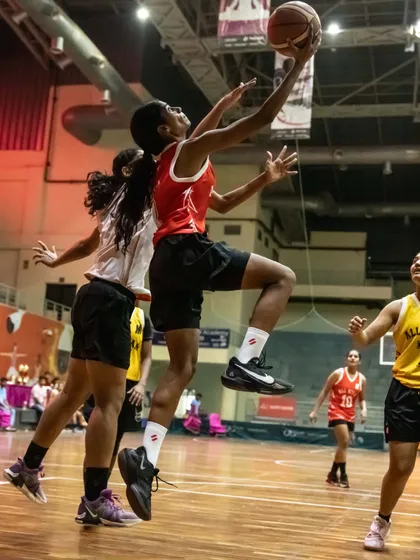 A female athlete goes for a layup in an All-Star game. We are committed to promoting women's basketball and providing equal opportunities for female players to showcase their talent.
