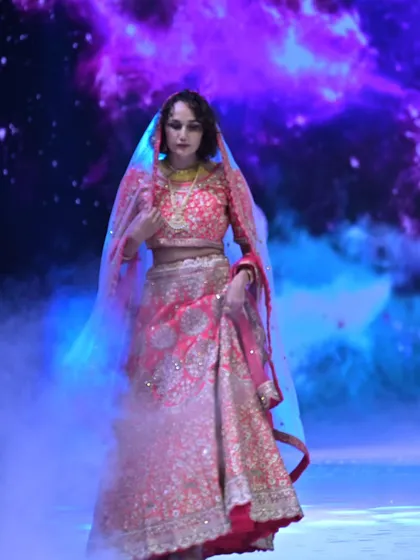 For the bride who loves drama and tradition, I created this opulent red lehenga. The rich embroidery and luxurious fabric are designed to make a powerful statement, blending classic Indian artistry with a modern, regal presence.
