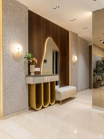 Step into serenity. This corner isn’t just decor, it’s a statement. From the sculptural mirror to the golden curves of the console, every detail speaks quiet luxury. Marble floors, mood lighting, and touches of green breathe life into this modern masterpiece.