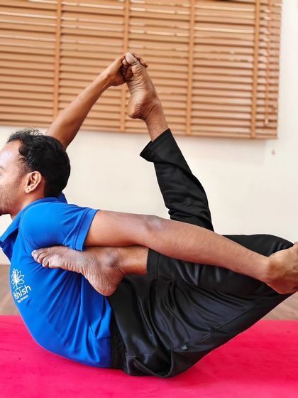 A deep backbend in Dhanurasana (Bow Pose), requiring both strength and flexibility.