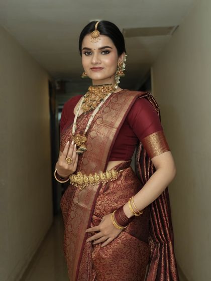 A confident pose showing the complete bridal ensemble. The makeup is designed to last through the long hours of a wedding day, looking fresh and flawless from the first ceremony to the last.