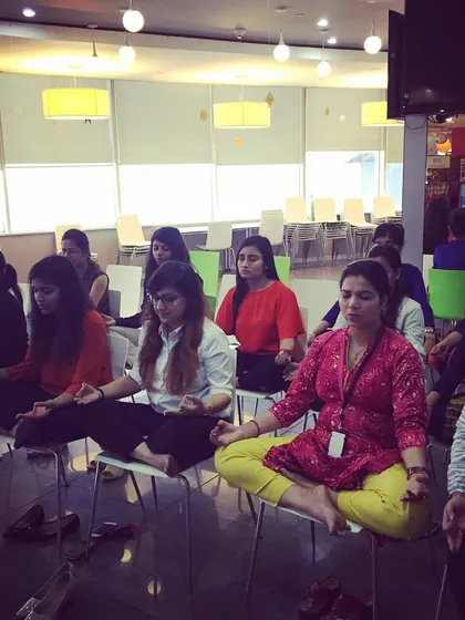 Bringing calm to the workplace is one of my passions. Here, we are practicing chair yoga and meditation during a corporate wellness session, a simple yet powerful way to reset during a busy day.