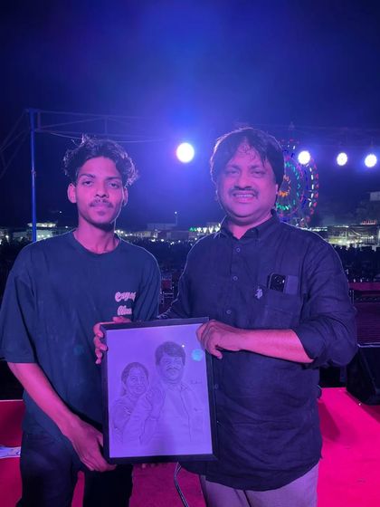 Presenting a custom portrait on stage. It's a special feeling to see my art being appreciated in public forums.