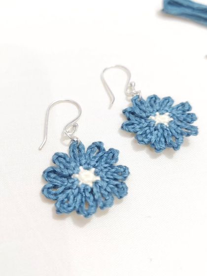 Dainty and elegant micro-crochet flower earrings in a beautiful shade of teal with a cream center.