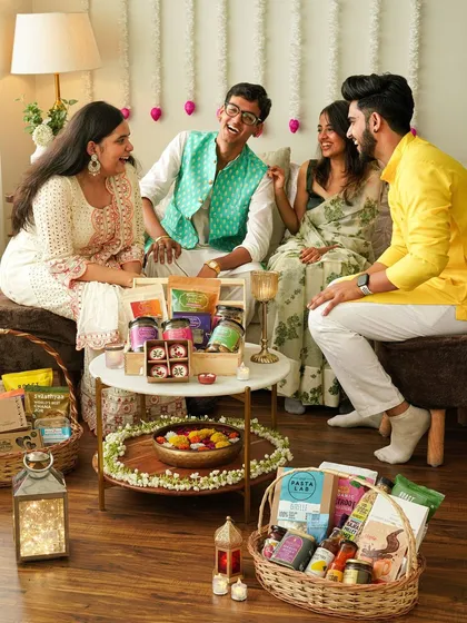 A wide shot of a festive get-together, capturing the happy, celebratory atmosphere of a Diwali party.