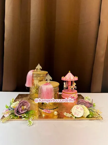The entire arrangement is presented on a golden tray with floral accents, creating a stunning visual.