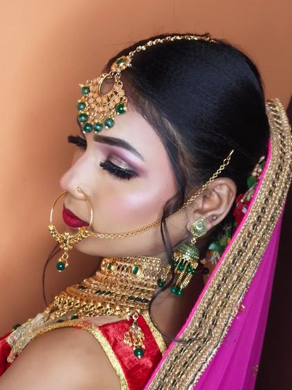 A side view showing the sleek hairstyle and the flawless makeup application.