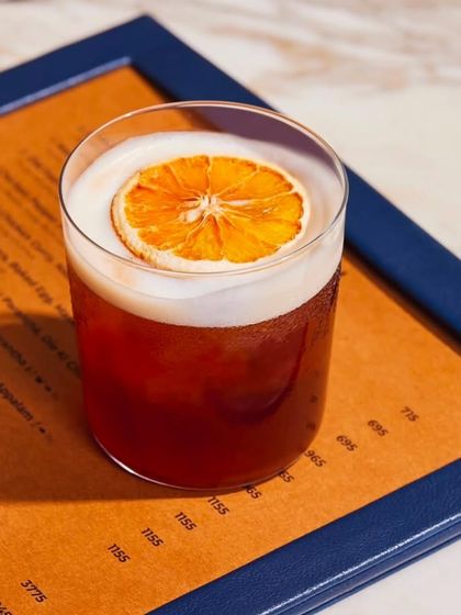 A classic sour-style cocktail, beautifully presented with a dehydrated orange wheel. This drink balances the boldness of the spirit with citrus and sweetness.