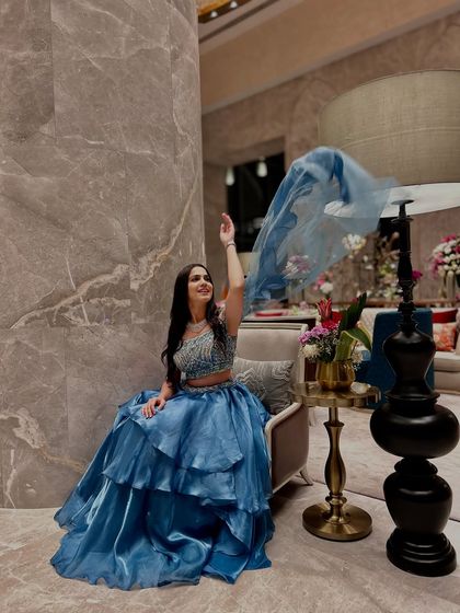A playful shot, tossing the dupatta of the gown to create a sense of movement and fun.