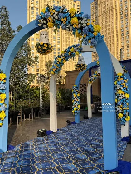 A series of floral arches creating a tunnel-like entrance for the Haldi ceremony, making for a grand and colorful welcome.