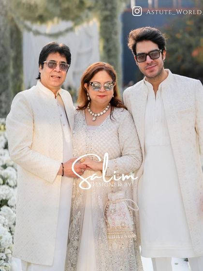 A family looking elegant in coordinated white and ivory outfits that I designed for a wedding event. Creating a cohesive look for a family is a service I truly enjoy.