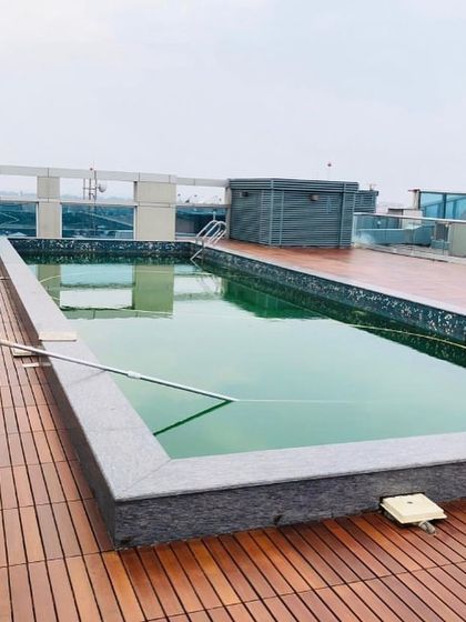 This rooftop installation showcases the beauty and functionality of IPE wood decking surrounding a pool. The wood's natural oils make it weather resistant, perfect for exposed urban environments.