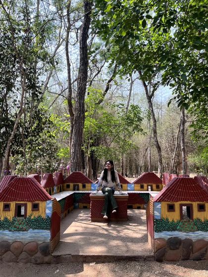 Sitting in a whimsical, village-themed installation within the park. I love discovering artistic and playful elements in unexpected places.