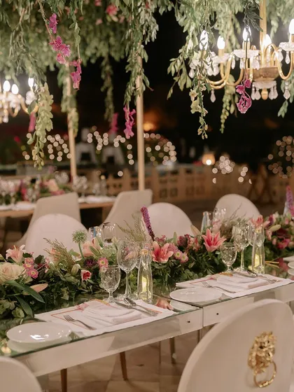 The art of celebration is in the details. This shot from a finale dinner shows our meticulous approach to tablescaping, where fresh floral arrangements, elegant glassware, and ambient lighting come together to create an unforgettable dining experience.