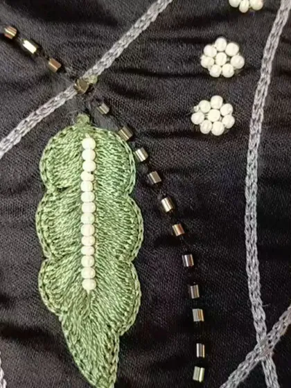 The intricate details of the embroidery, showing the combination of threadwork and beading that makes this co-ord set so special.