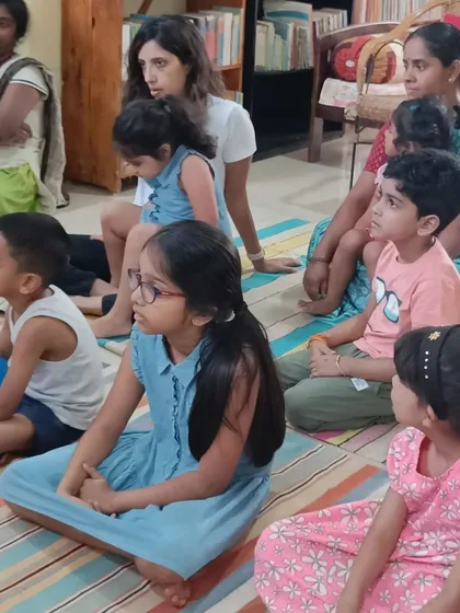 Parents and children listen together, making story time a shared family experience.
