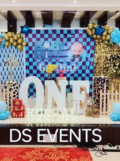 Here is a Boss Baby themed stage decoration for a first birthday. I created a complete look with a custom checkered backdrop, a large light-up "ONE" sign, and character cutouts, turning the venue into a scene from the movie.