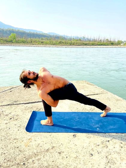 A twisting lunge pose practiced by the Ganga river, combining strength, balance, and a connection to nature.