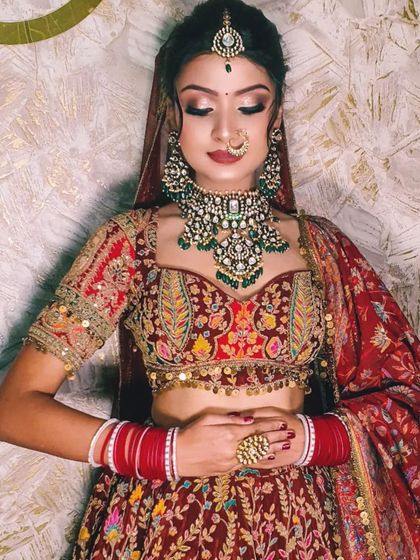 A detailed shot of the heavily embroidered blouse and the stunning green and polki necklace.