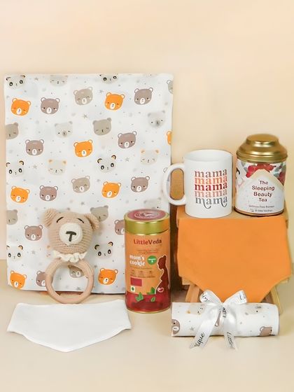 A gift set for a new mom, including a 'mama' mug and specialty teas, alongside items for the baby. This is a great example of a thoughtful, multi-recipient hamper.