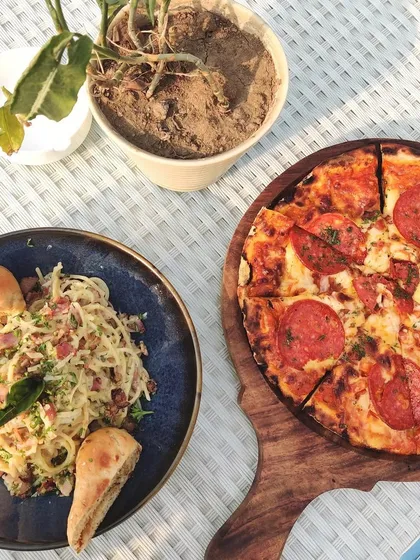A delicious spread of pepperoni pizza and carbonara pasta, perfect for refueling after a long practice session on the range.