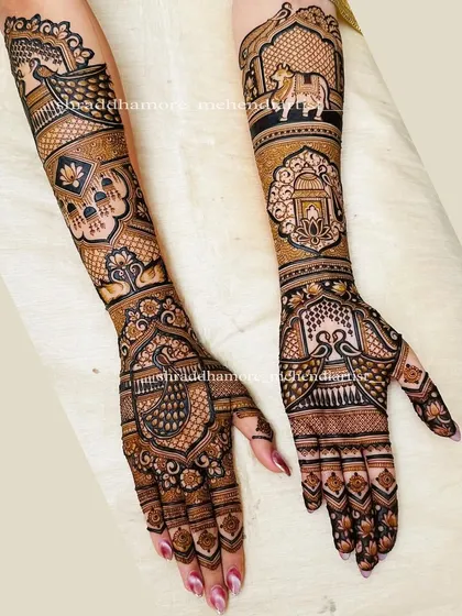 A full view of a personalized bridal mehendi, featuring a sacred Nandi bull on one arm and a lantern on the other, symbolizing light and guidance.
